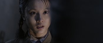 Movie still from “Coming Home” (2014), directed by Yimou Zhang – A young girl is looking into the camera; Close Up shot, Over the shoulder angle