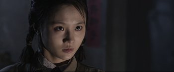 Movie still from “Coming Home” (2014), directed by Yimou Zhang – A young woman is looking into the camera; Close Up shot, Low angle