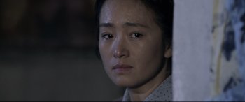 Movie still from “Coming Home” (2014), directed by Yimou Zhang – A person wearing a white shirt; Close Up shot, Over the shoulder angle