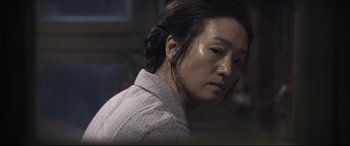 Movie still from “Coming Home” (2014), directed by Yimou Zhang – A person wearing a white shirt; Close Up shot, Over the shoulder angle