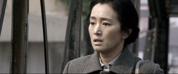 Movie still from “Coming Home” (2014), directed by Yimou Zhang – A person wearing a coat; Close Up shot, Over the shoulder angle
