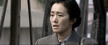 Movie still from “Coming Home” (2014), directed by Yimou Zhang – A person wearing a jacket; Close Up shot, Over the shoulder angle