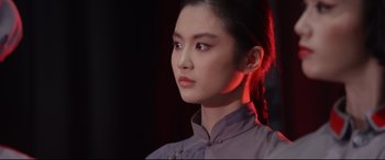 Movie still from “Coming Home” (2014), directed by Yimou Zhang – A young woman with long red hair wearing a purple shirt; Close Up shot, Low angle