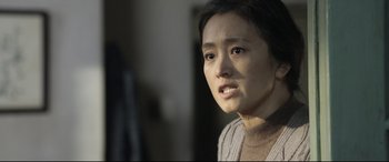 Movie still from “Coming Home” (2014), directed by Yimou Zhang – A person looking at the camera; Close Up shot, Over the shoulder angle