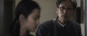Movie still from “Coming Home” (2014), directed by Yimou Zhang – A man and a woman sitting next to each other in a room; Close Up shot, Over the shoulder angle