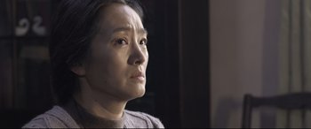 Movie still from “Coming Home” (2014), directed by Yimou Zhang – A person looking at the camera; Close Up shot, Over the shoulder angle