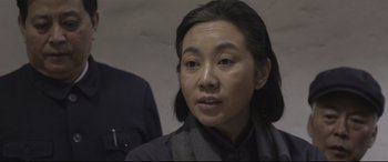 Movie still from “Coming Home” (2014), directed by Yimou Zhang – A person wearing a black shirt; Close Up shot, Over the shoulder angle