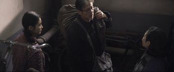 Movie still from “Coming Home” (2014), directed by Yimou Zhang – An older man with a bag on his shoulder; Medium shot, Over the shoulder angle