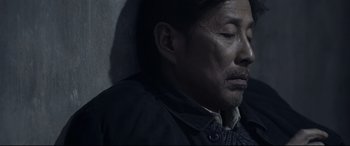 Movie still from “Coming Home” (2014), directed by Yimou Zhang – A person wearing a jacket; Close Up shot, High angle