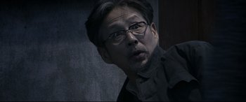 Movie still from “Coming Home” (2014), directed by Yimou Zhang – A person wearing glasses; Close Up shot, Over the shoulder angle