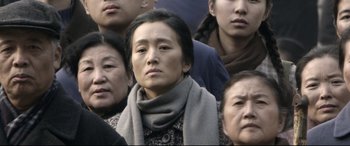 Movie still from “Coming Home” (2014), directed by Yimou Zhang – A group of people standing around each other in a crowd; Close Up shot, High angle