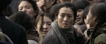 Movie still from “Coming Home” (2014), directed by Yimou Zhang – A group of people standing next to each other; Close Up shot, High angle