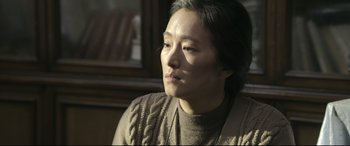 Movie still from “Coming Home” (2014), directed by Yimou Zhang – A woman sitting in front of a window looking off into the distance; Close Up shot, Over the shoulder angle