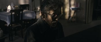 Movie still from “Coming Home” (2014), directed by Yimou Zhang – An older man wearing glasses looking down at a laptop computer; Close Up shot, Low angle