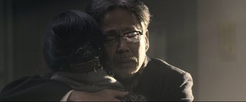 Movie still from “Coming Home” (2014), directed by Yimou Zhang – An older man is holding a young girl; Close Up shot, Over the shoulder angle