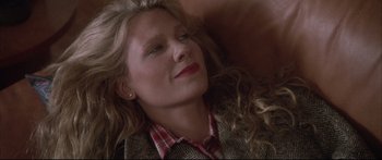 Movie still from “Communion” (1989), directed by Philippe Mora – A person laying on the ground; Close Up shot, High angle