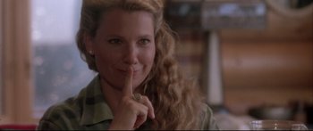 Movie still from “Communion” (1989), directed by Philippe Mora – A person with a finger on her mouth; Close Up shot, Over the shoulder angle