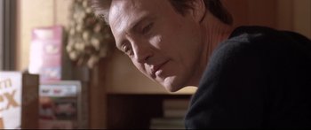 Movie still from “Communion” (1989), directed by Philippe Mora – A man's face in a dark room; Close Up shot, Low angle