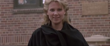 Movie still from “Communion” (1989), directed by Philippe Mora – A woman with blonde hair wearing a black jacket; Close Up shot, Low angle