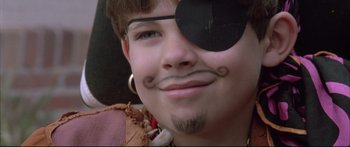Movie still from “Communion” (1989), directed by Philippe Mora – A young man with a pirate eye patch; Close Up shot, Over the shoulder angle