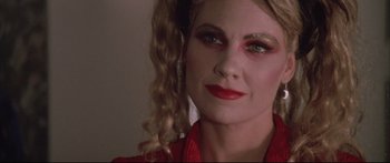 Movie still from “Communion” (1989), directed by Philippe Mora – A person wearing a red shirt; Close Up shot, Low angle