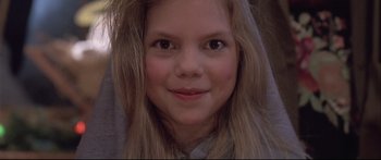 Movie still from “Communion” (1989), directed by Philippe Mora – A person with long hair; Close Up shot, High angle