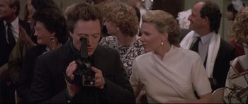 Movie still from “Communion” (1989), directed by Philippe Mora – Two women are looking at a video camera; Close Up shot, Over the shoulder angle