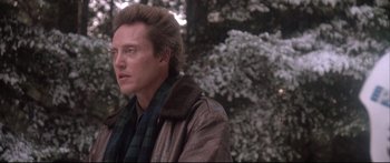 Movie still from “Communion” (1989), directed by Philippe Mora – A person wearing a jacket and a scarf; Close Up shot, Low angle