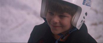 Movie still from “Communion” (1989), directed by Philippe Mora – A young boy wearing a helmet and a jacket; Close Up shot, Low angle