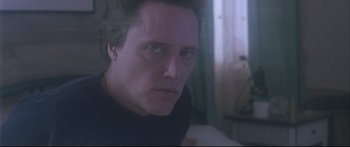 Movie still from “Communion” (1989), directed by Philippe Mora – A person looking at the camera; Close Up shot, Low angle