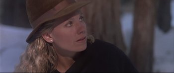 Movie still from “Communion” (1989), directed by Philippe Mora – A person wearing a hat and looking up; Close Up shot, Low angle