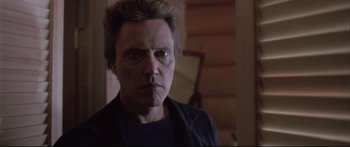 Movie still from “Communion” (1989), directed by Philippe Mora – A person wearing a black shirt; Close Up shot, Low angle