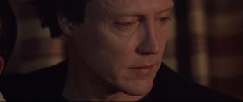 Movie still from “Communion” (1989), directed by Philippe Mora – A man's face in a dimly - lit room; Close Up shot, High angle