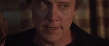 Movie still from “Communion” (1989), directed by Philippe Mora – A man's face with tears coming out of his eyes; Close Up shot, Low angle