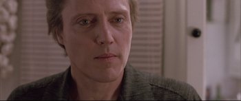 Movie still from “Communion” (1989), directed by Philippe Mora – A man's face in a room; Close Up shot, Low angle