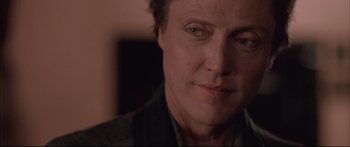 Movie still from “Communion” (1989), directed by Philippe Mora – A man's face in a dark room; Close Up shot, Low angle