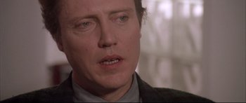 Movie still from “Communion” (1989), directed by Philippe Mora – A person looking at the camera; Close Up shot, Over the shoulder angle