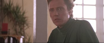 Movie still from “Communion” (1989), directed by Philippe Mora – A man in a green shirt is looking at the camera; Close Up shot, Low angle