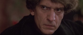 Movie still from “Communion” (1989), directed by Philippe Mora – A man's face as he stares into the camera; Close Up shot, Low angle