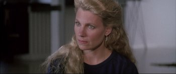 Movie still from “Communion” (1989), directed by Philippe Mora – A person with long blonde hair; Close Up shot, High angle