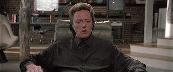 Movie still from “Communion” (1989), directed by Philippe Mora – A man sitting in a chair with his eyes closed; Close Up shot, Low angle