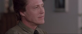 Movie still from “Communion” (1989), directed by Philippe Mora – A person wearing a shirt and a tie; Close Up shot, Low angle