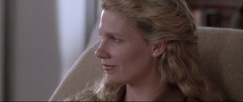 Movie still from “Communion” (1989), directed by Philippe Mora – A person with long hair; Close Up shot, Over the shoulder angle