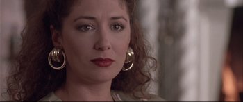 Movie still from “Communion” (1989), directed by Philippe Mora – A person wearing a gold earring; Close Up shot, Low angle