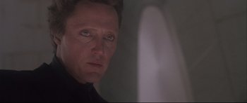 Movie still from “Communion” (1989), directed by Philippe Mora – A person looking at the camera; Close Up shot, Low angle