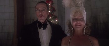 Movie still from “Communion” (1989), directed by Philippe Mora – A man and a woman dressed up for a party; Close Up shot, Low angle
