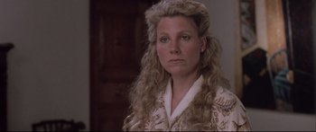 Movie still from “Communion” (1989), directed by Philippe Mora – A person with long hair; Close Up shot, Over the shoulder angle