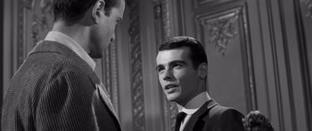Movie still from “Compulsion” (1959), directed by Richard Fleischer – A man in a suit talking to another man in a suit; Close Up shot, Low angle