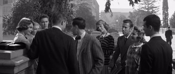 Movie still from “Compulsion” (1959), directed by Richard Fleischer – A black and white photo of a group of men and women; Medium shot, Over the shoulder angle