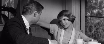 Movie still from “Compulsion” (1959), directed by Richard Fleischer – An old photo of a man and a woman; Medium shot, Over the shoulder angle